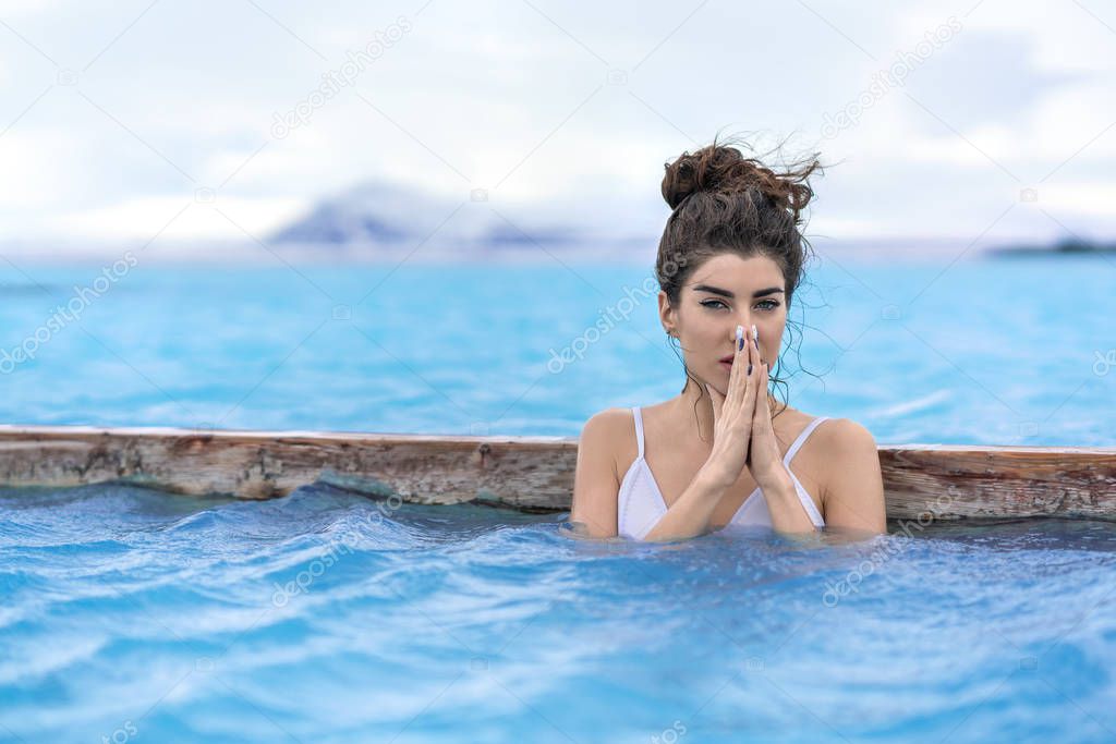 Girl relaxing in geothermal pool outdoors
