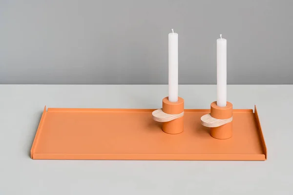 Metal orange support and candlesticks — Stock Photo, Image