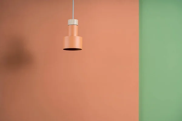 Hanging metal orange lamp with wooden part — Stock Photo, Image