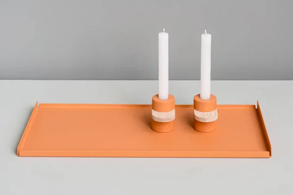 Metal orange support and candlesticks — Stock Photo, Image