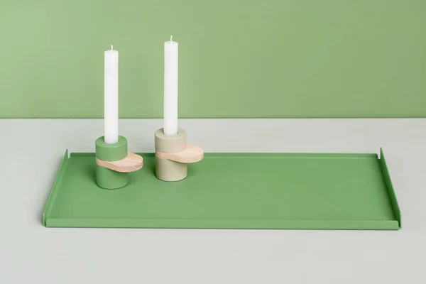 Metal green support and candlesticks — Stock Photo, Image