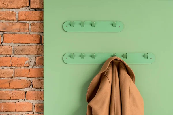 Metal green hangers with jacket — Stock Photo, Image