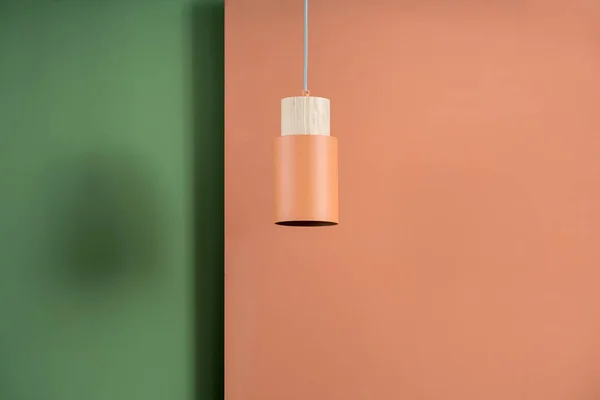 Hanging metal orange lamp with wooden part — Stock Photo, Image