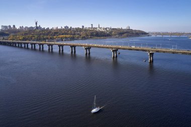 Nehir üzerinde köprüsü olan güneşli şehir manzarası