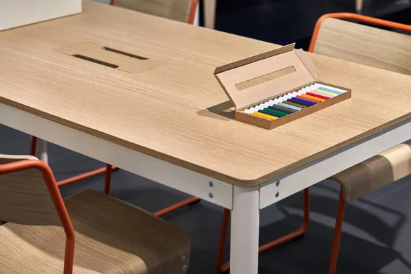 Caja de cartón con marcadores multicolores se encuentra en la mesa de madera —  Fotos de Stock