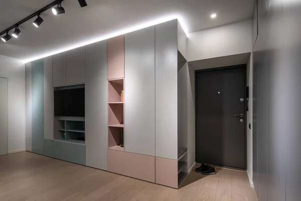 Interior of illuminated modern flat with multicolored cabinets — Stock Photo, Image