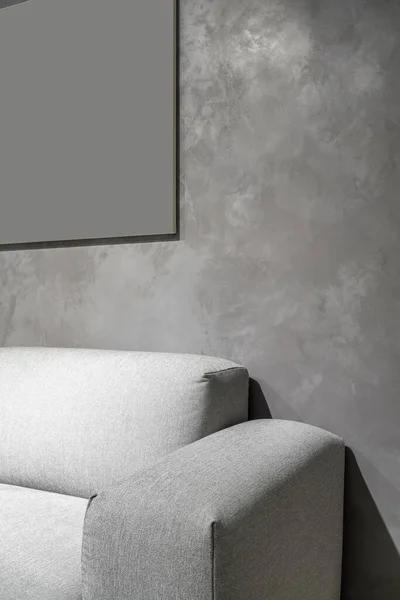 Interior of illuminated modern flat with textured gray wall