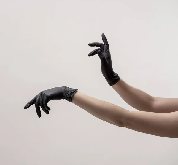 Hands in black silicone gloves on a light background. — Stock Photo, Image