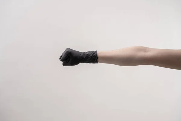 Handen in zwarte siliconen handschoenen op een lichte ondergrond. — Stockfoto