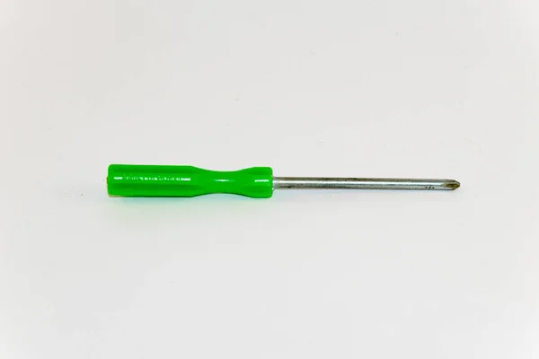 Small green screwdriver on a white background — Stock Photo, Image