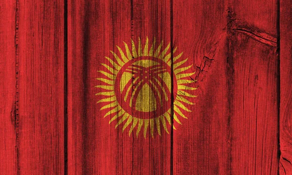 Bandeira do Quirguistão pintada na parede de madeira para fundo — Fotografia de Stock