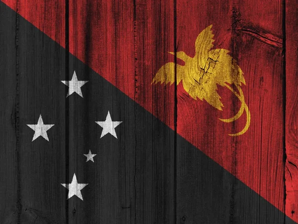 배경에 대 한 나무 벽에 그려진 파푸아 뉴 기니 깃발 — 스톡 사진
