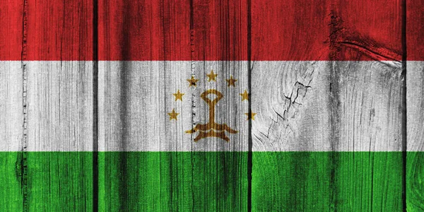 タジキスタンの国旗を背景に木製の壁に描かれました。 — ストック写真