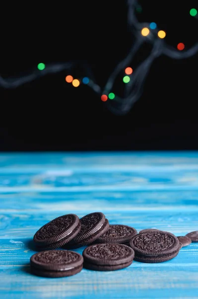 Chocolate biscuits with a bright herring on the table