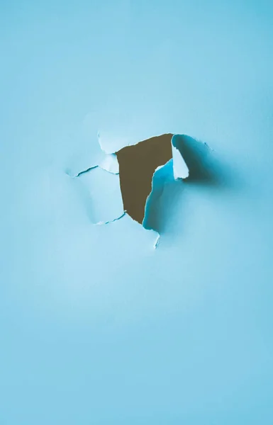 Лист голубой бумаги с дырой в центре . — стоковое фото