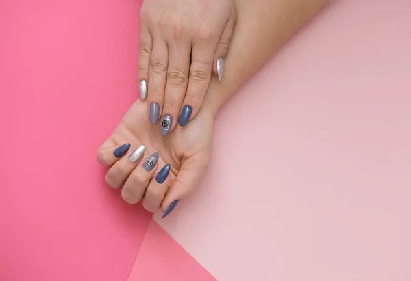 Mooie stijlvolle vrouwelijke manicure op een roze achtergrond. — Stockfoto