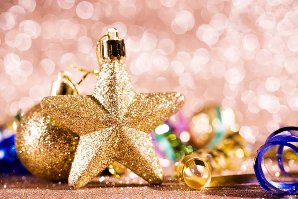 Festive content on a glittery background of gold color with serpentine, toys, sparkles. — Stock Photo, Image