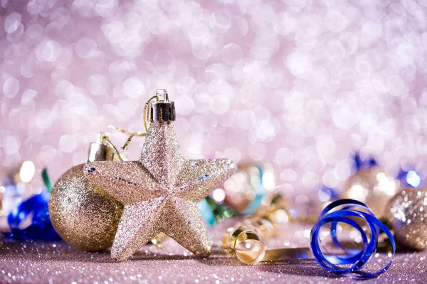 Festive content on a glittery background of gold color with serpentine, toys, sparkles. — Stock Photo, Image