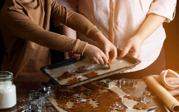 The process of baking chocolate cookies, different forms. Indigrens on the table, the hands of the pastry chef, desserts.