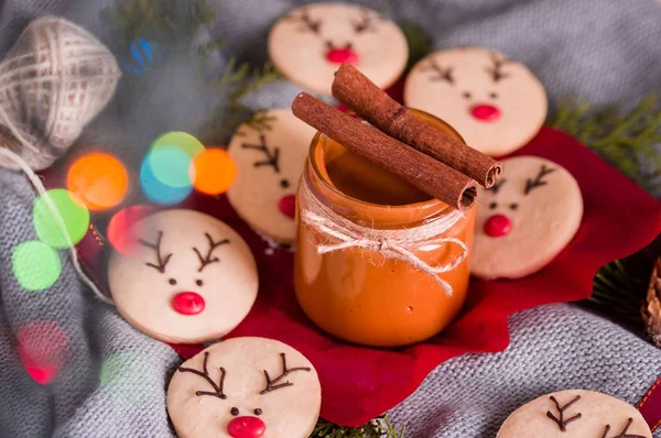 Tasty and fragrant chocolate chip cookies are crushed with powdered sugar, with multi-colored lights on the table. Merry Christmas — Stock Photo, Image