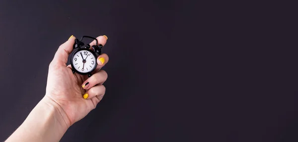 Black Little Alarm Clock His Hand Black Background Place Text — Stock Photo, Image