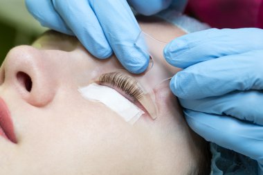 Woman on the procedure eyelash, clipart