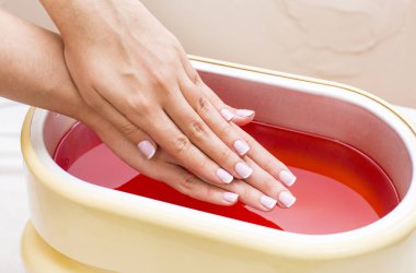 process paraffin treatment of female hands clipart