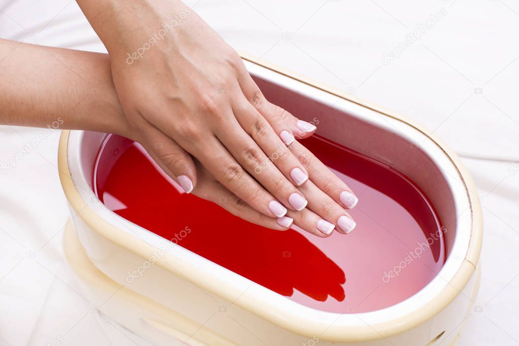 Process paraffin treatment of female hands 