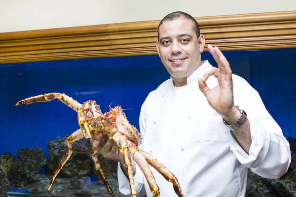 Chef of the fish restaurant with seafood l