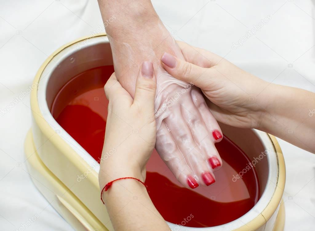 Process paraffin treatment of female hands 
