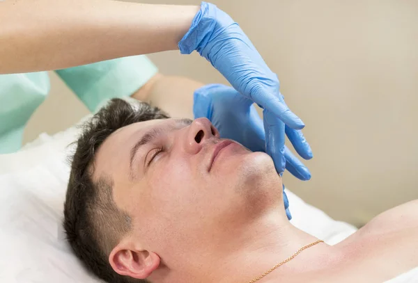 Man in the mask cosmetic procedure — Stock Photo, Image