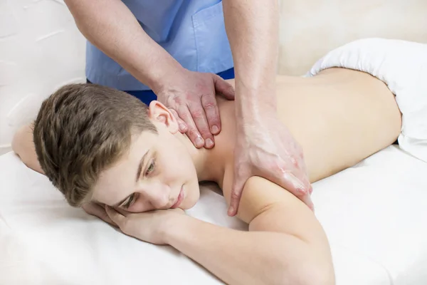 teenager on the procedure of medical medical sports body massage