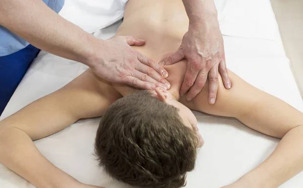 Teenager on the procedure of medical medical sports body massage — Stock Photo, Image