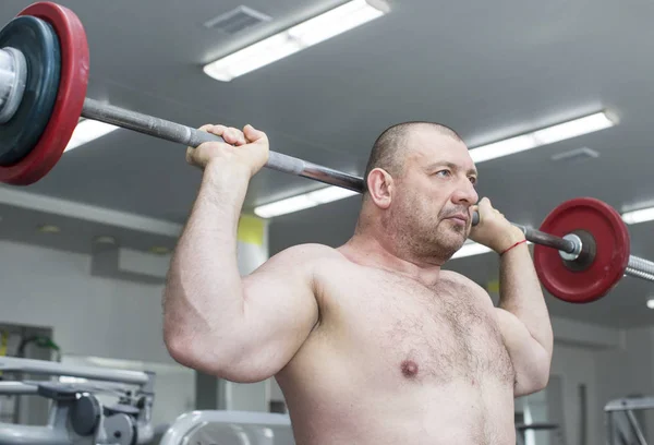 Man is engaged in power bodybuilding in the gym — Stock Photo, Image
