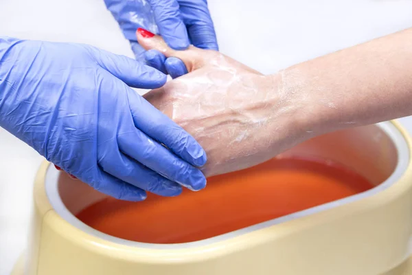 Process paraffin treatment of female hands — Stock Photo, Image
