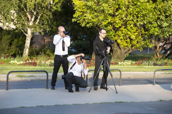 Un groupe de photographes de mariage dans les rues de Budapest organise une séance photo pour quelques jeunes mariés . — Photo