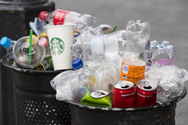 Sokak çöp kutularını tarar üst kadar plastik şişe ile çöp kutuları ile dolu.