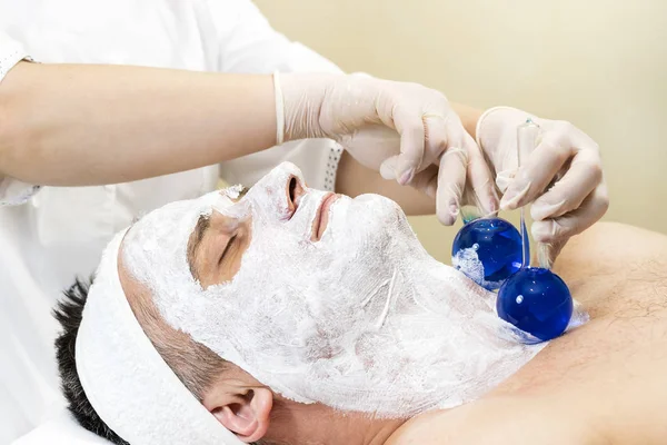 Man in the mask cosmetic procedure in spa salon.