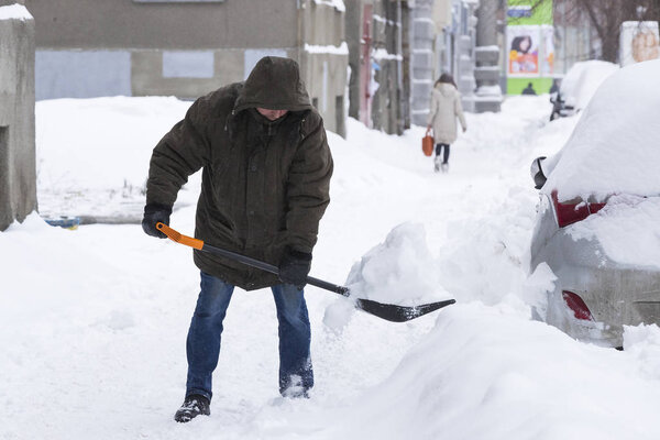KHARKOV, UKRAINE- 1 MARCH 2018: Cleaning of the streets of the city by residents and public utilities in the period of climatic cataclysm of large snowfalls.