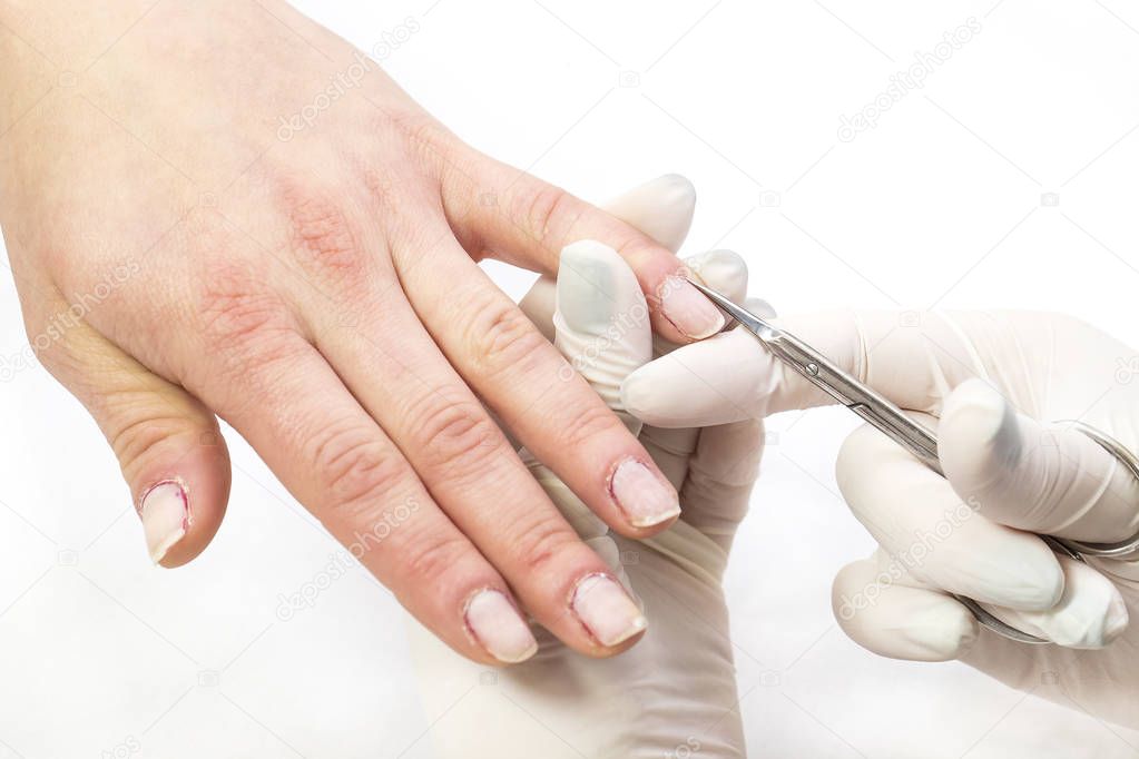 The process of the master's work in the manicure salon of female nails.