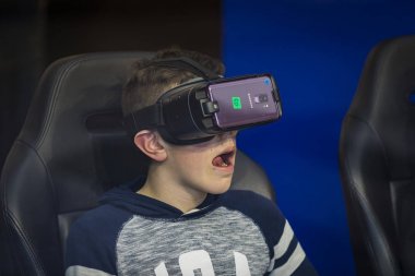 MADRID, SPAIN - 28 Mart 2018: Çocuklar Samsung merkez mağazasının merkezinde Samsung Gear VR sanal gerçeklik gözlüklerini test ediyorlar.