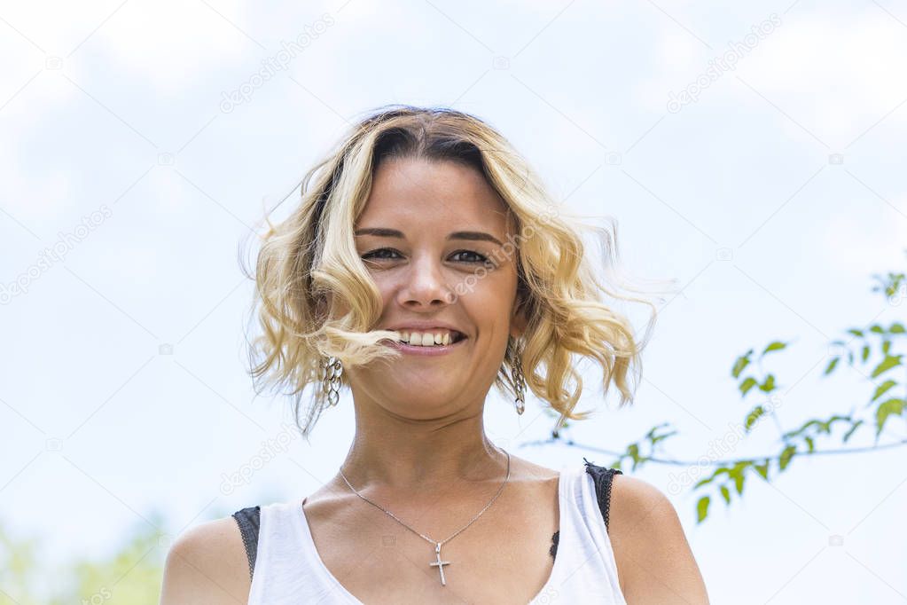 Portrait of a girl in a summer park outdoors 