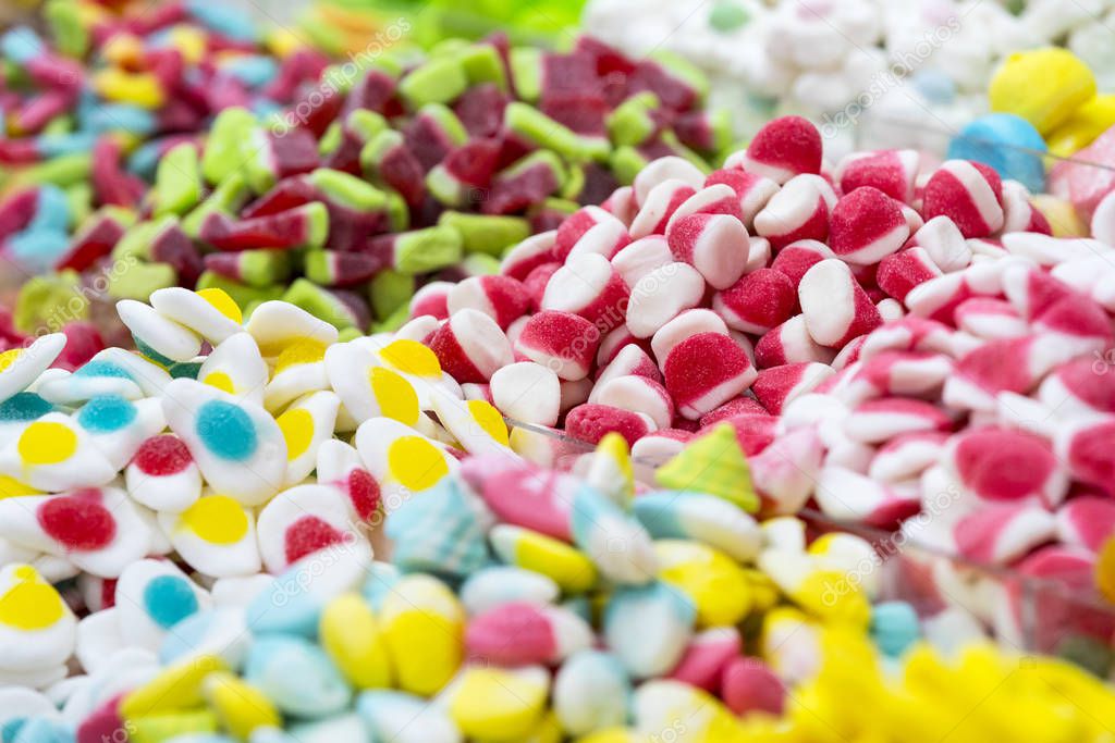 Assortment of jellied colored sweets as a product background 