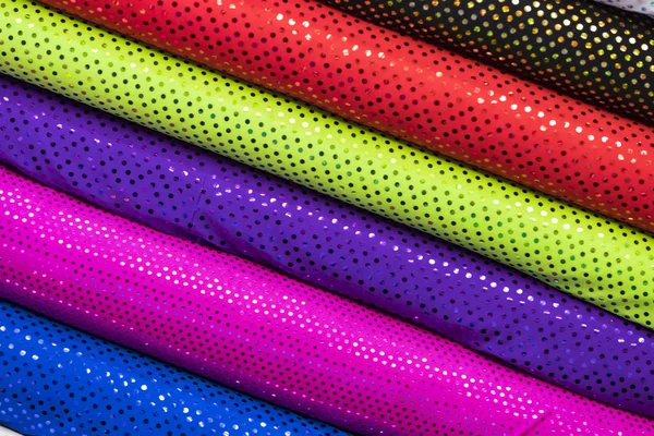 Background of the scrolls rolls colored colorful fabric