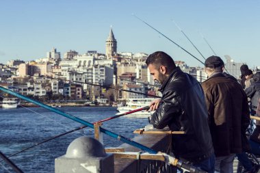 Istanbul, Türkiye - 1 Nisan, 2017: balıkçılar Galata Köprüsü'nde balık Haliç Bay Türkiye'de