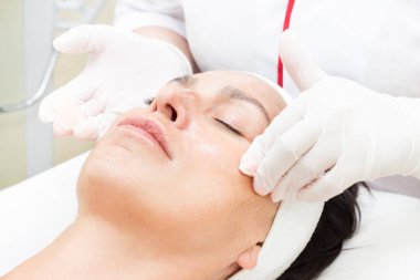 Güzellik salonunda kadın kozmetik maskesi ve chistak yüz prosedürü.