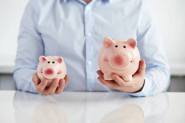 Man with two piggy banks — Stock Photo, Image