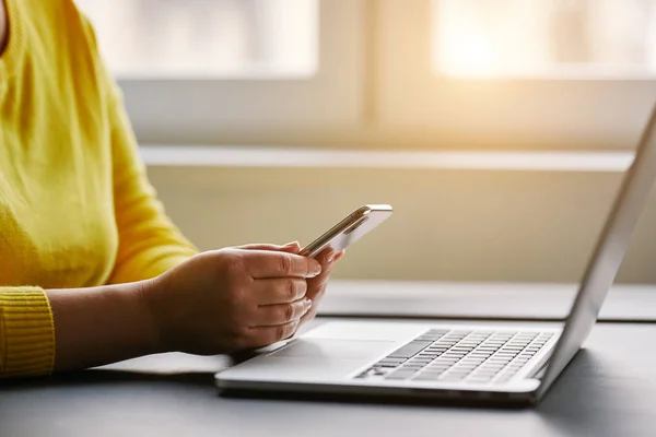 Female hands with mobile phone and laptop — Stock Photo, Image