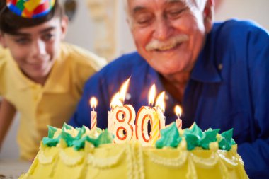Çocuk ve kıdemli pasta doğum günü partisi üfleme mumlar dostum