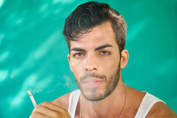 Adam ciddi bir ifadeyle Sigara — Stok fotoğraf